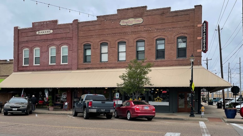 An older building in downtown Rosenberg, Texas, with storefront signs that say "Bakery" and "Another Time."