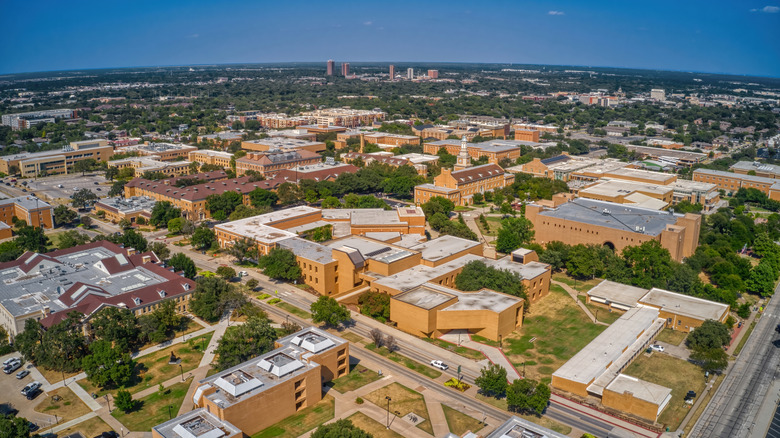 Aerial view of a sprawling urban landscape with university buildings and tree-lined streets in Denton, Texas
