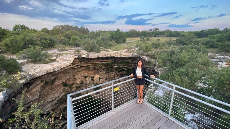 Woman smiling on the viewing platform at Devil's Sinkhole State Natural Area, Texas