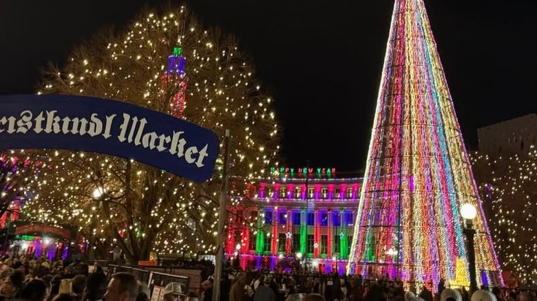 Christmas tree, sign, and lights at Denver Christkindlmarket