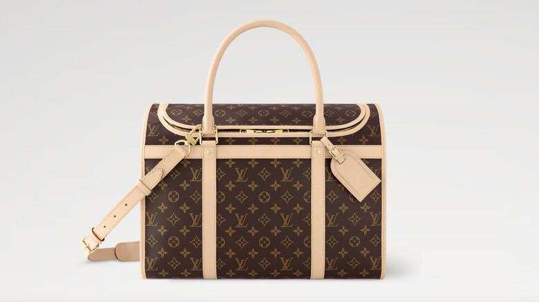 View of Louis Vuitton Monogram canvas pet carrier sitting on a white background