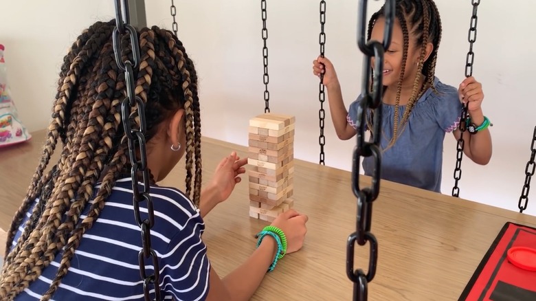 Two girls playing Jinga on swings at the Paradisus Palma Real kids club