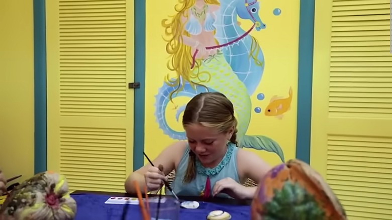 A child painting at the kids club at The Buccaneer resort