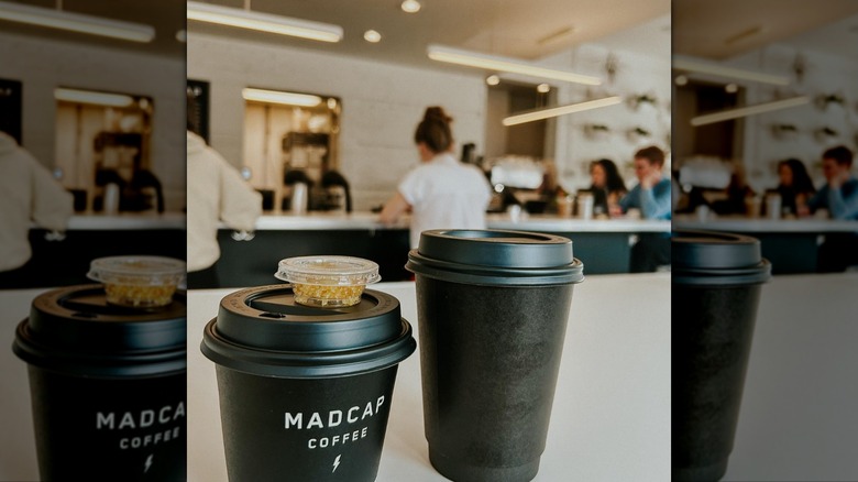 Two takeout cups of coffee on a bar in Grand Rapids.