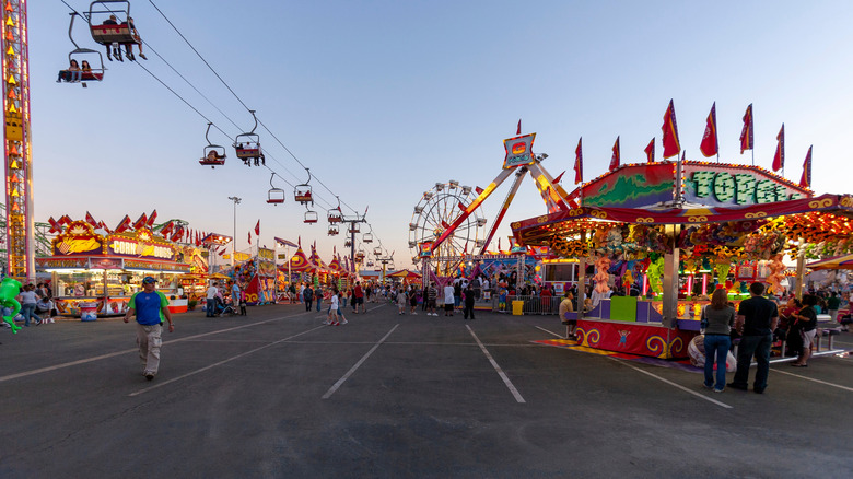People walk by concession stands at the state fairgrounds in Phoenix, Arizona
