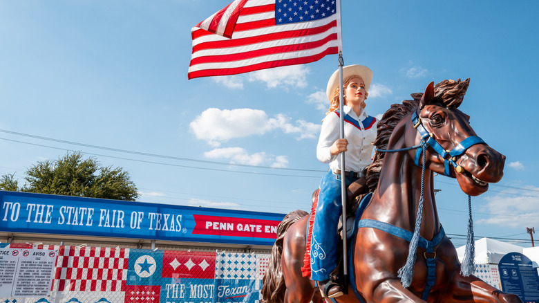 A statued horseback rider carrying an American flag is seen at the State Fair of Texas, Dallas