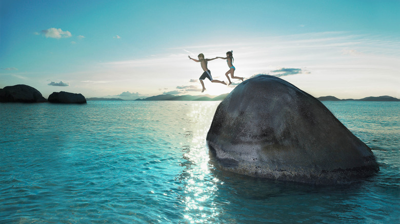 People jumping into the ocean
