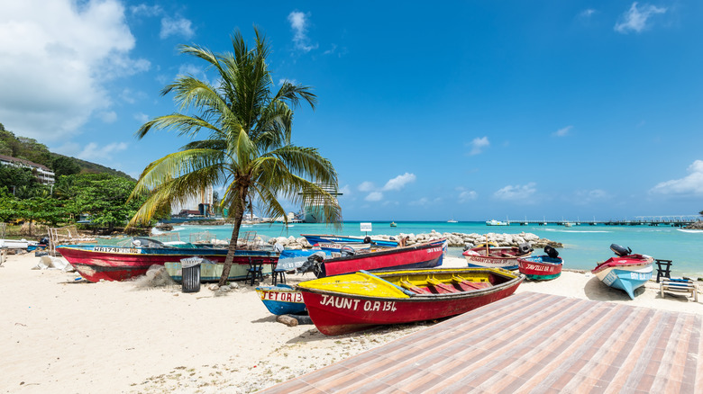 Colorful boats along the sandy shoreline in Jamaica