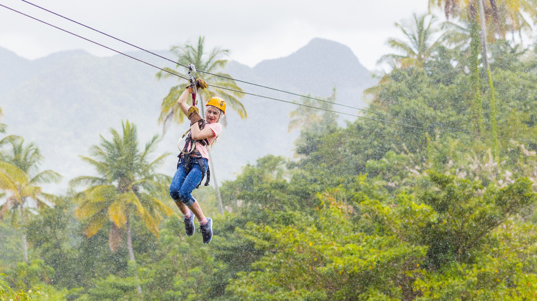 A female tourist zip-lining in the Caribbean
