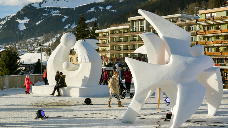 people walking between large ice sculptures