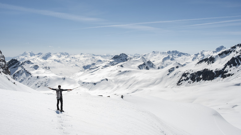 hiker snowshoeing on mountain
