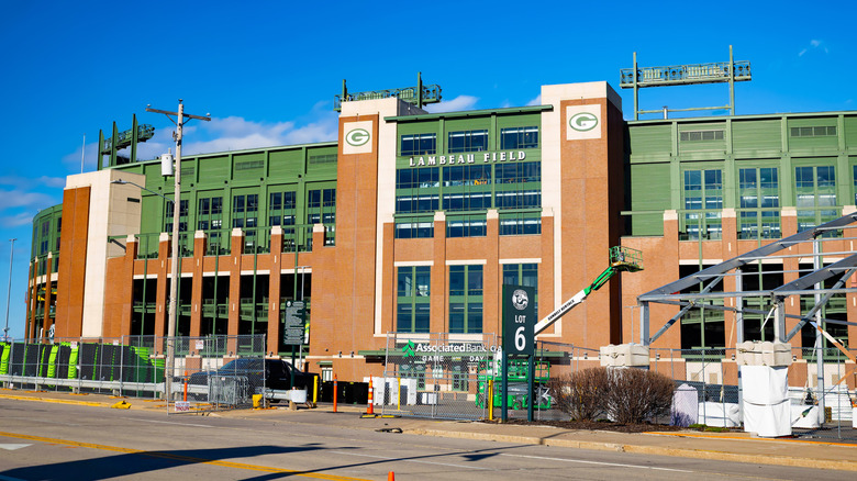 Exterior view of Lambeau Field in Green Bay, Wisconsin on a sunny day with some construction materials outside the gate