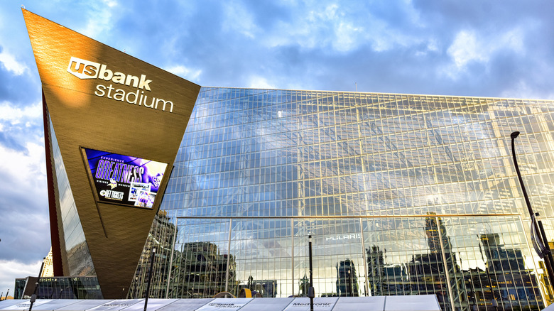 Side view of U.S. Bank Stadium at golden era with "Experience Greatness" on the outdoor digital sign