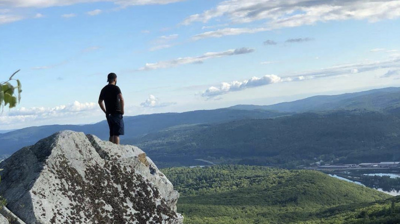 A man standing on the Wantastiquet Mountain overlook