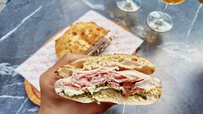 Person holding Italian sandwich