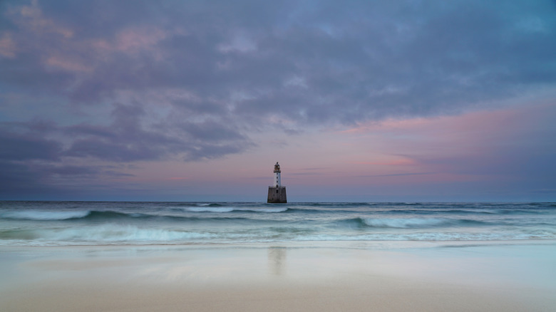 Rattray Head Lighthouse, as seen from Rattray Beach during high tide at sunset