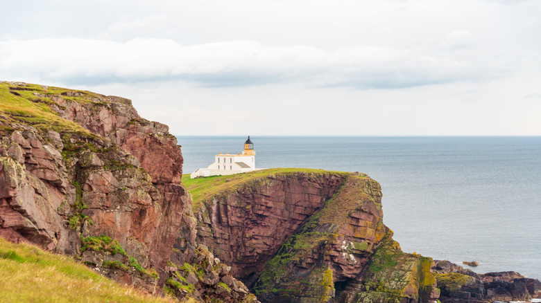 Stoer Lighthouse against the ocean, as seen on a cloudy day