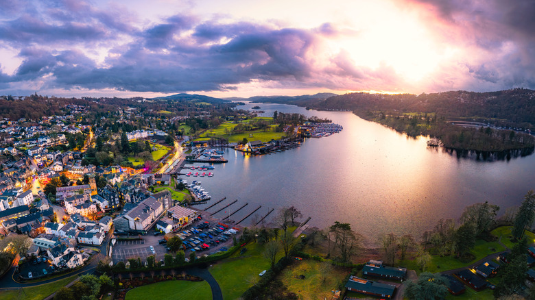 Stunning high-angle aerial photograph capturing the iconic lakeside town of Bowness-on-Windermere, on the shores of Lake Windermere in the Lake District National Park, Cumbria, United Kingdom, at golden hour sunset