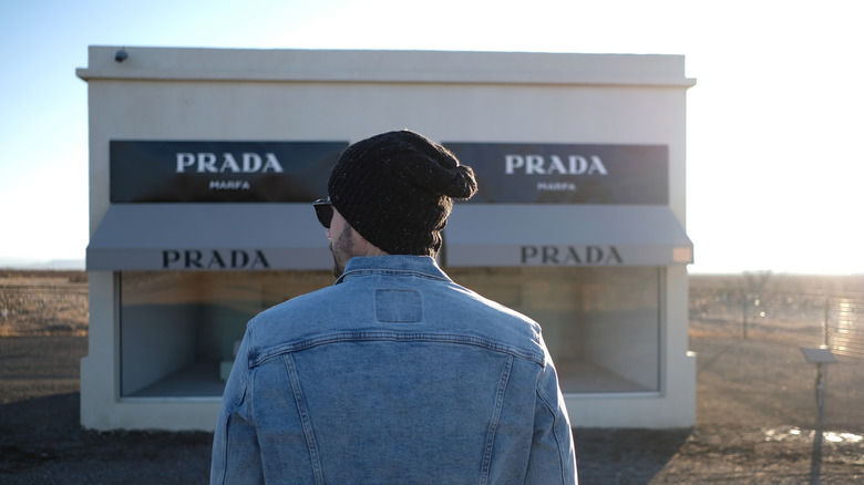 A visitor looking at the'Prada Marfa' art installation
