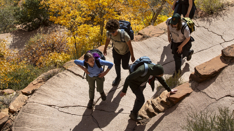 Hikers make their way up the steep and winding Angels Landing Trail.