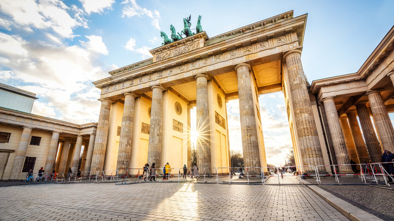 Brandenburg gate at sunset with solar flare, Berlin, Germany