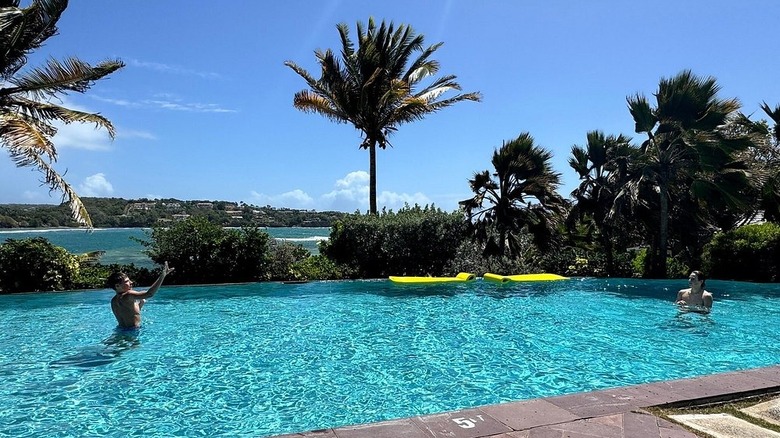 Two people swimming in the pool at Cocoa Cove Resort in Grenada