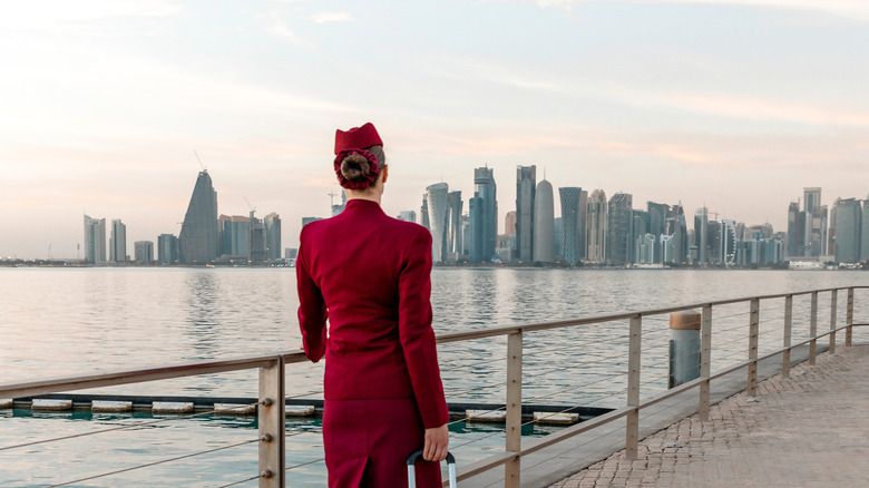Flight attendant walking down a boardwalk in Doha