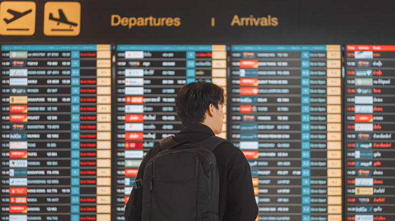 Traveler looking at flight board