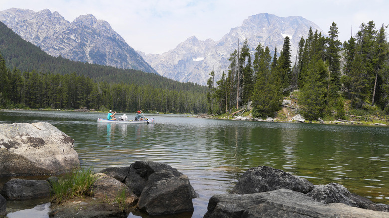 People paddle in a canoe in Leigh Lake in Grand Teton National Park, Wyoming