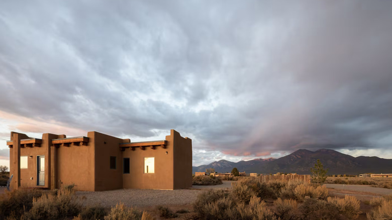 adobe home with mountains in the background