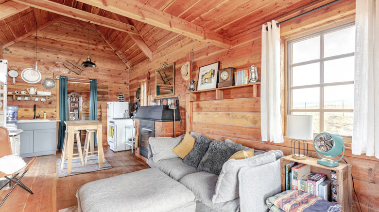 Living room and kitchen with window overlooking landscape