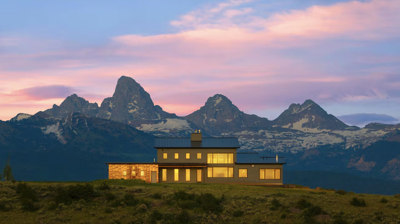 Modern house at twilight with mountains in background