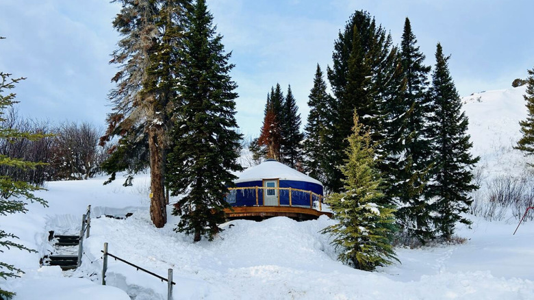 Blue yurt in snowy mountains