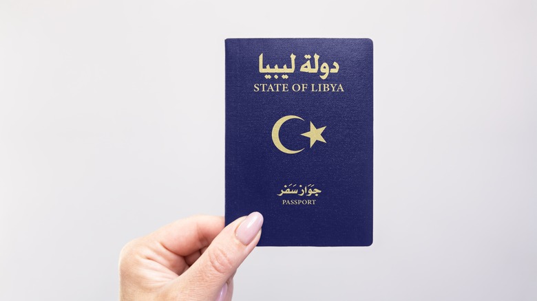 Hand holding a Libyan passport