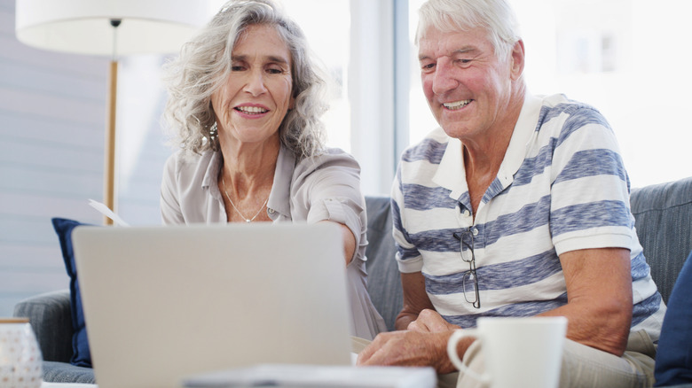 Senior couple consulting websites
