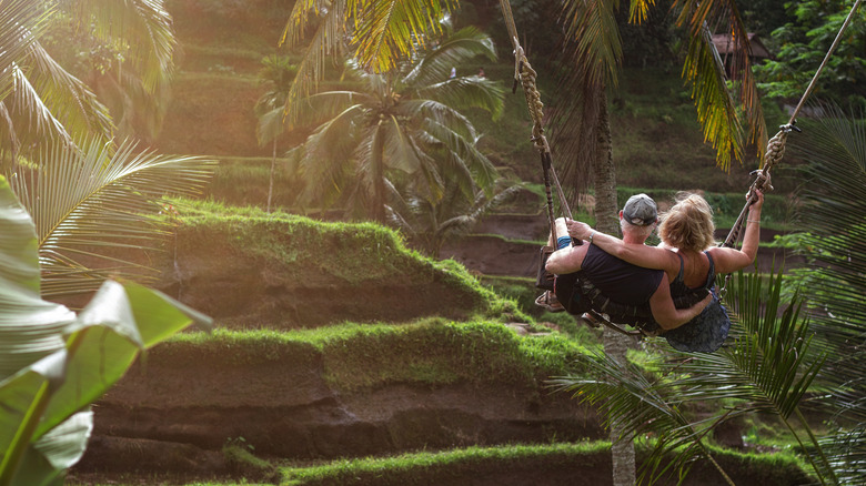 Senior couple on a swing in Ubud