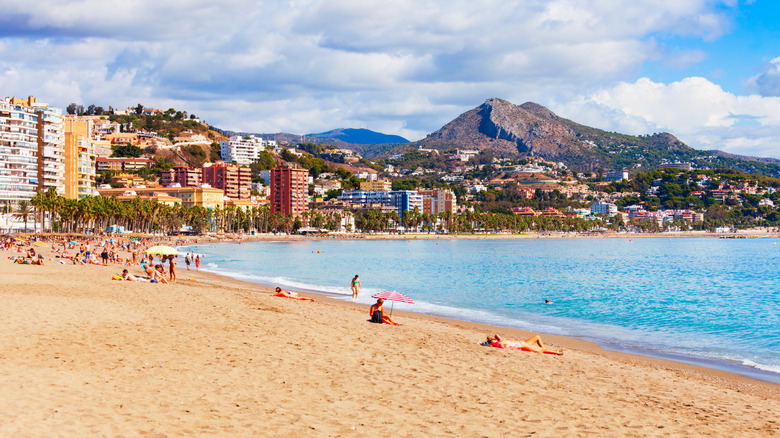 Sunny beach in Malaga, Spain, with mountains in the background