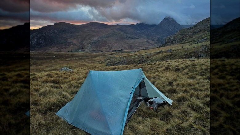 The Durston X-Mid 2 tent in a field by a mountain