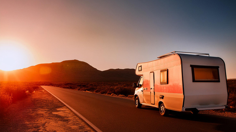 An RV drives up a highway in California