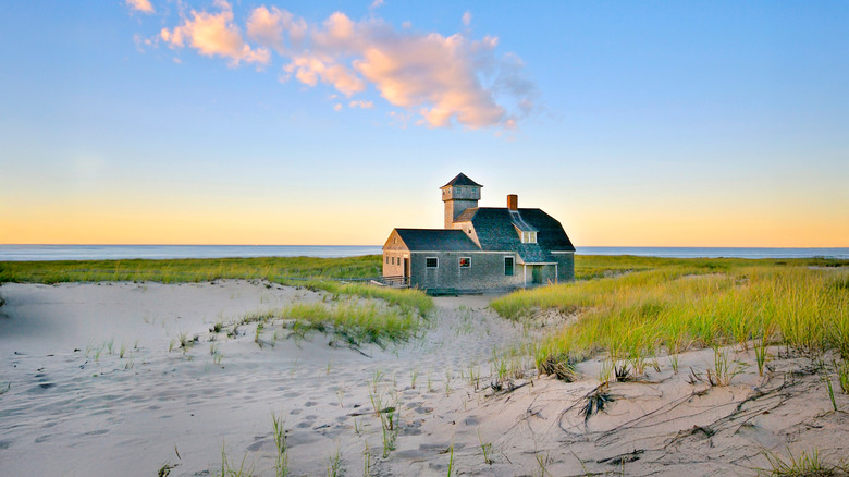 A solitary beach house on Cape Cod at sunset