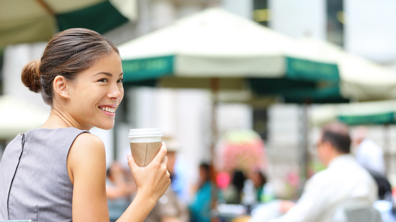 A woman enjoys a coffee in NYC
