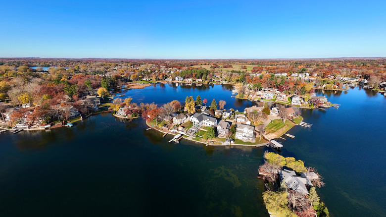 Houses surrounded by fall foliage on peninsula of Lake Orion