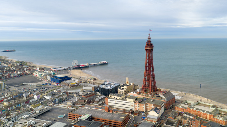 Aerial view of Blackpool Tower and seafront with pier beach promenade in Blackpool, Lancashire, UK