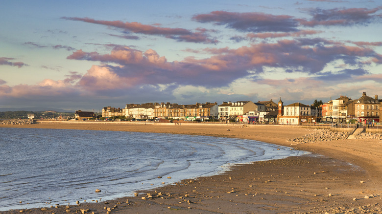 The beach at sunset, with a rising tide in Morecambe, Lancashire, UK