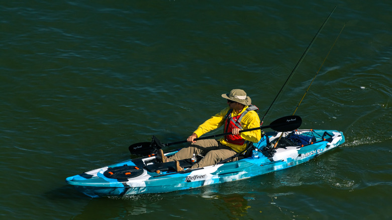 An angler in a kayak paddles on Gavelston Bay