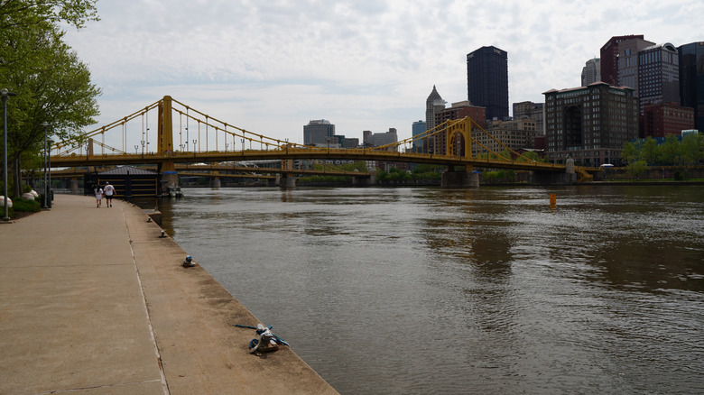 The Pittsburgh skyline, the yellow Roberto Clemente Bridge, and the Allegheny River from the Three Rivers Heritage Trail