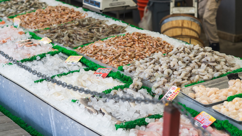 A seafood counter with fresh fish and shellfish options over ice
