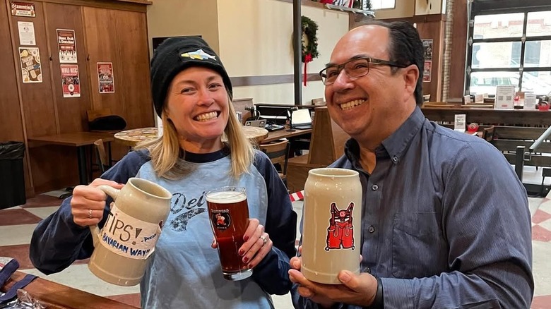 Two people enjoy big steins and good vibes at Kusterer Brauhaus
