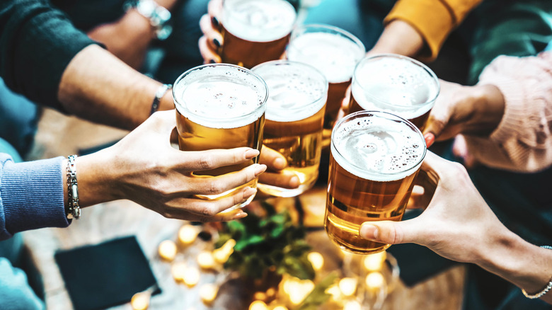 Group of people toasting mugs of German beer