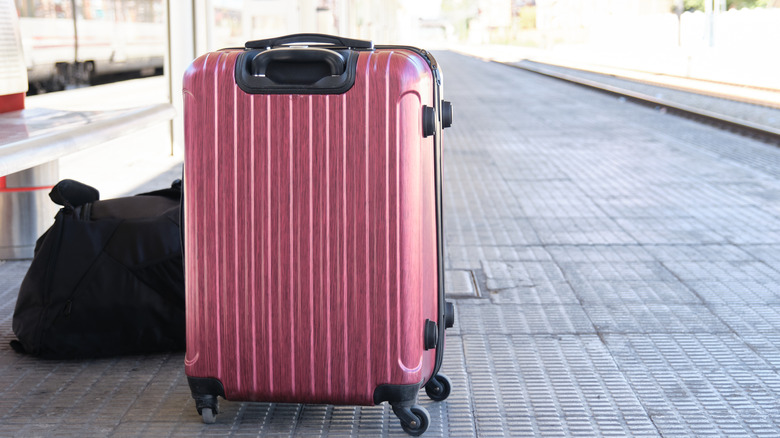 A luggage standing by a subway